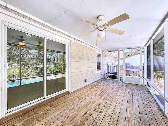 unfurnished sunroom with a ceiling fan