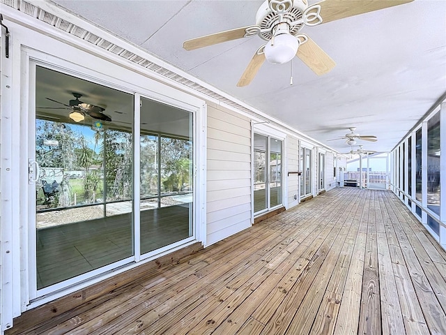 wooden deck featuring a ceiling fan