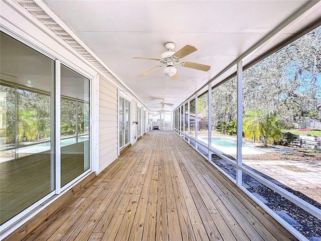 wooden deck with a ceiling fan