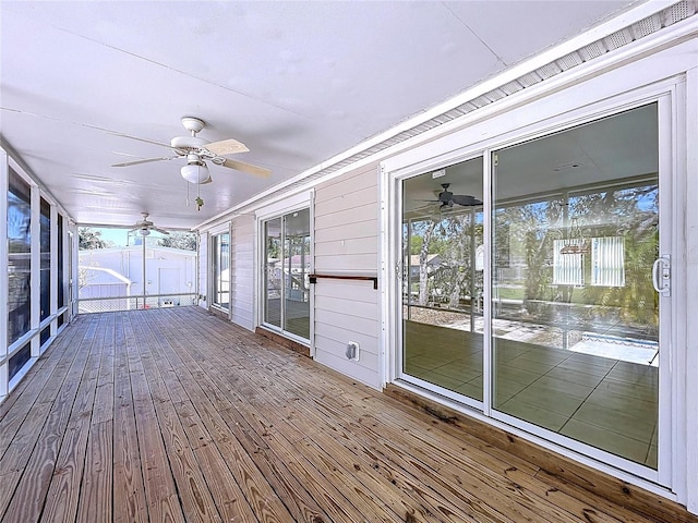 unfurnished sunroom with plenty of natural light and ceiling fan