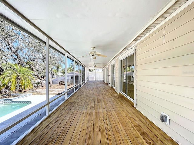 wooden deck featuring an outdoor pool and a ceiling fan