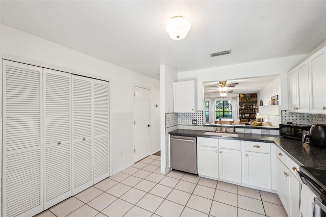 kitchen featuring visible vents, electric range oven, a sink, stainless steel dishwasher, and dark countertops