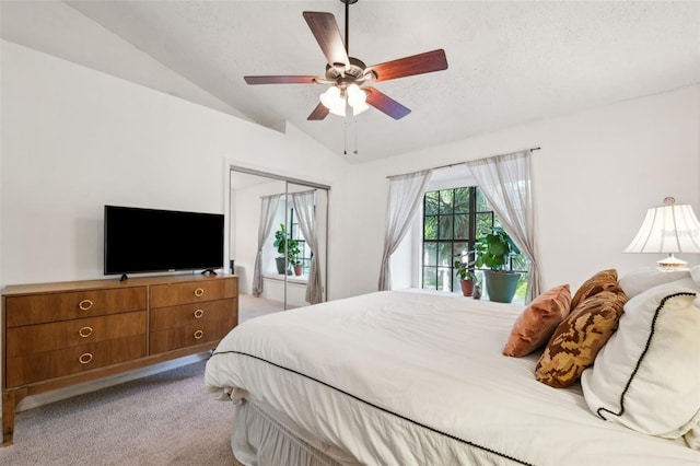 bedroom with light colored carpet, a textured ceiling, ceiling fan, and vaulted ceiling