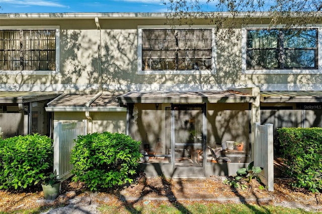 rear view of property with stucco siding