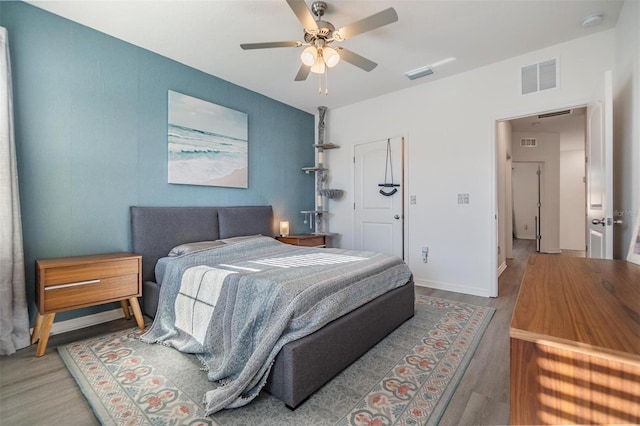 bedroom featuring visible vents and wood finished floors