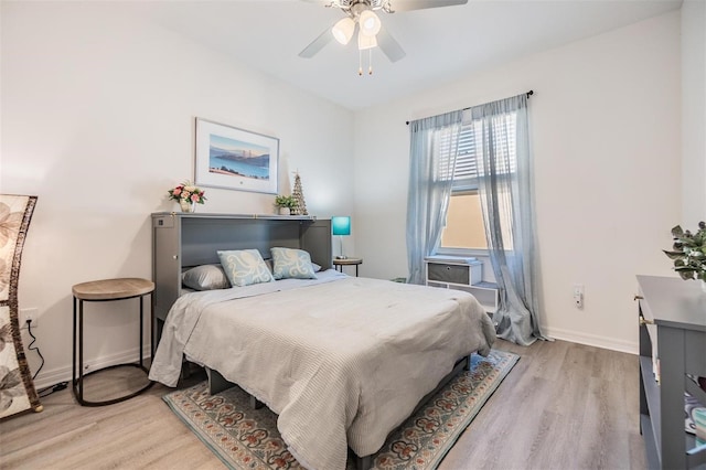 bedroom featuring baseboards, light wood-style flooring, and a ceiling fan