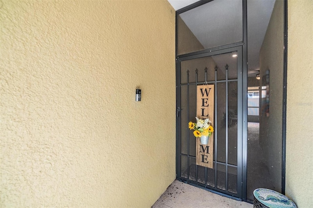 entrance to property with stucco siding