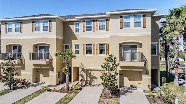 view of property featuring an attached garage and stucco siding