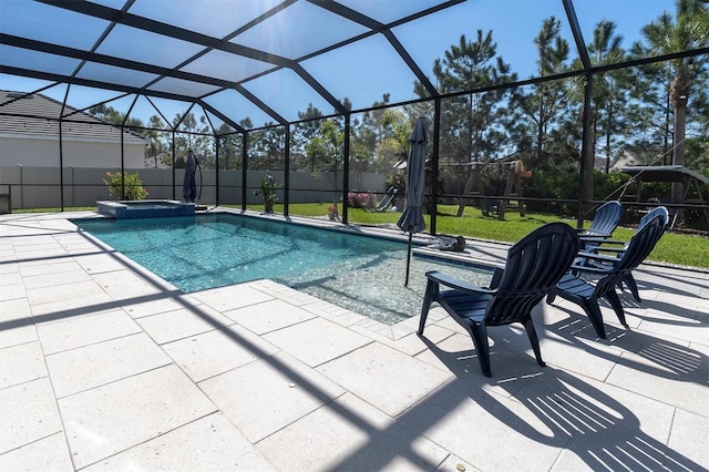 view of pool with fence, a lanai, and a patio area