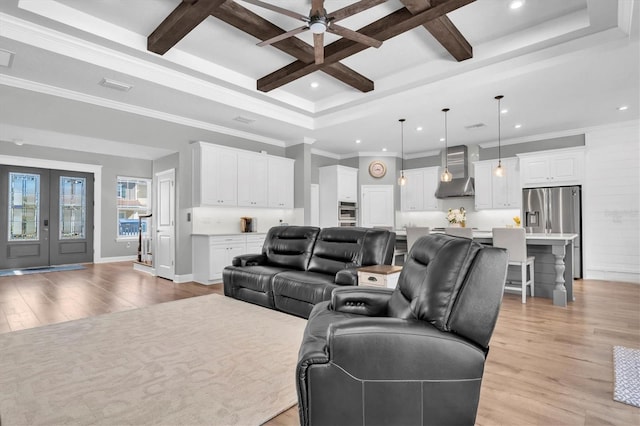 living room featuring french doors, beam ceiling, coffered ceiling, and light wood finished floors