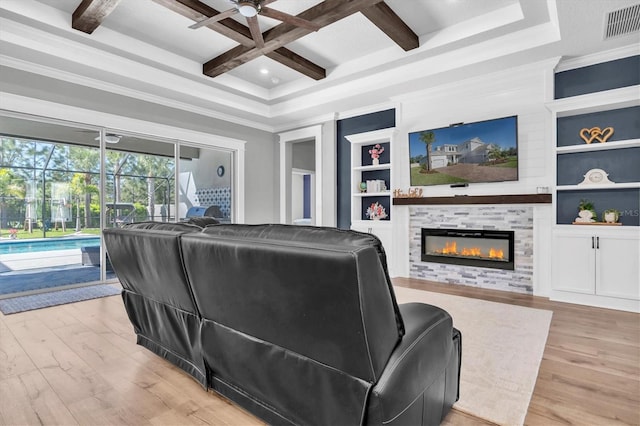 living room featuring built in features, wood finished floors, visible vents, and coffered ceiling