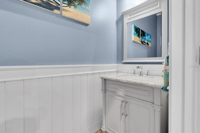 bathroom featuring wainscoting and vanity