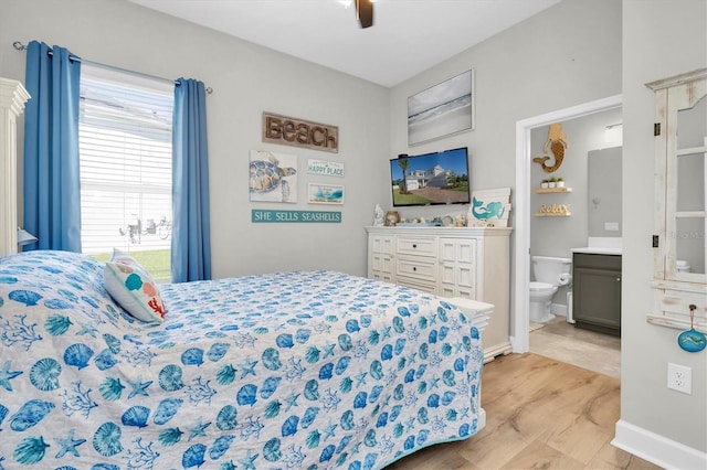 bedroom with connected bathroom, wood finished floors, and a ceiling fan