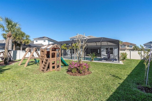 view of playground featuring glass enclosure, a yard, and a fenced backyard