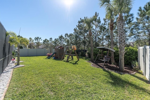 view of yard with a fenced backyard and a playground