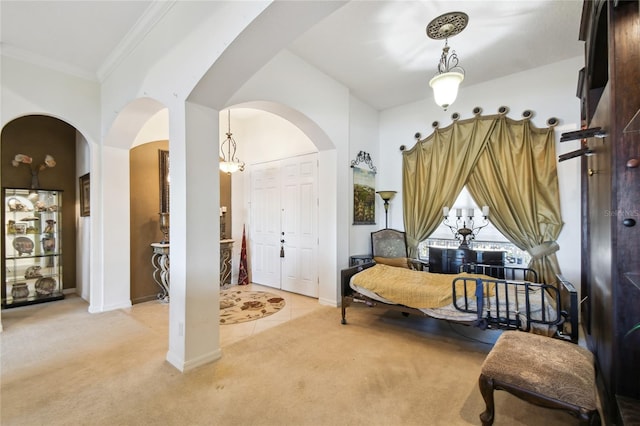 entryway featuring crown molding, baseboards, arched walkways, and light carpet