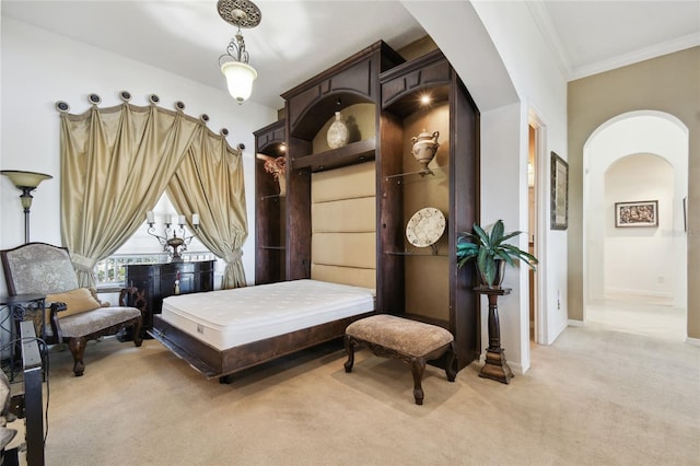 bedroom featuring crown molding, light colored carpet, arched walkways, and baseboards