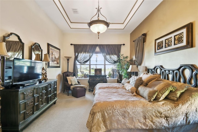 carpeted bedroom with visible vents and a raised ceiling