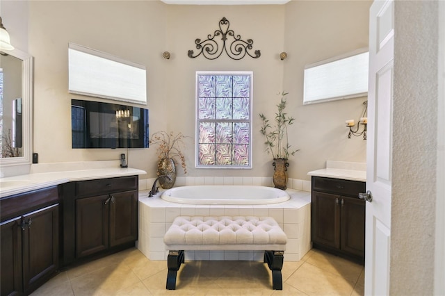 full bathroom featuring tile patterned floors, a garden tub, and vanity