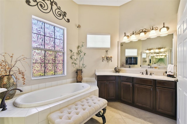 full bath featuring tile patterned floors, a garden tub, and vanity