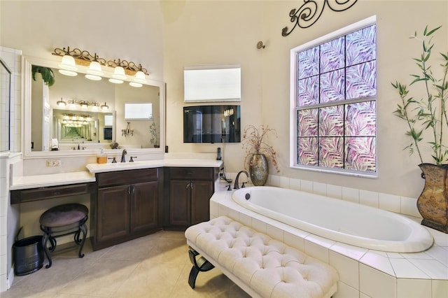 bathroom featuring tile patterned floors, a garden tub, and vanity