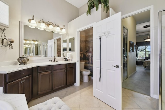 full bath with tile patterned flooring, toilet, vanity, and ensuite bathroom