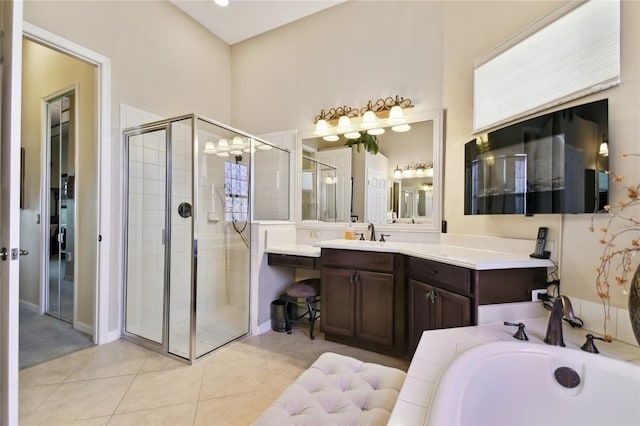 bathroom with tile patterned flooring, a garden tub, vanity, and a stall shower