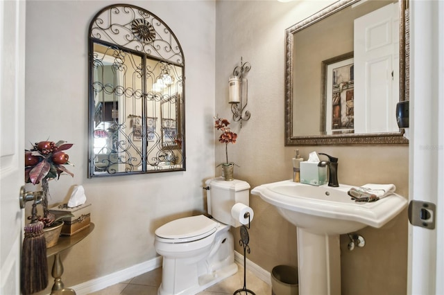 bathroom with tile patterned floors, toilet, and baseboards