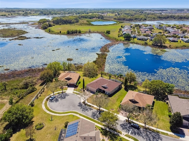 drone / aerial view with a residential view and a water view