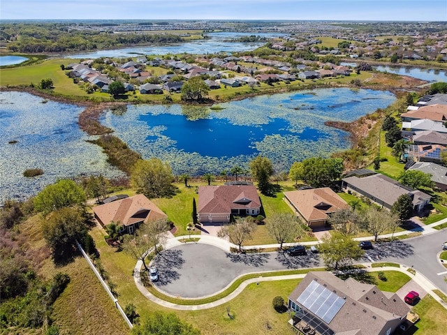 drone / aerial view featuring a residential view and a water view