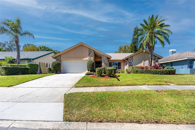 view of front facade with concrete driveway, an attached garage, and a front yard