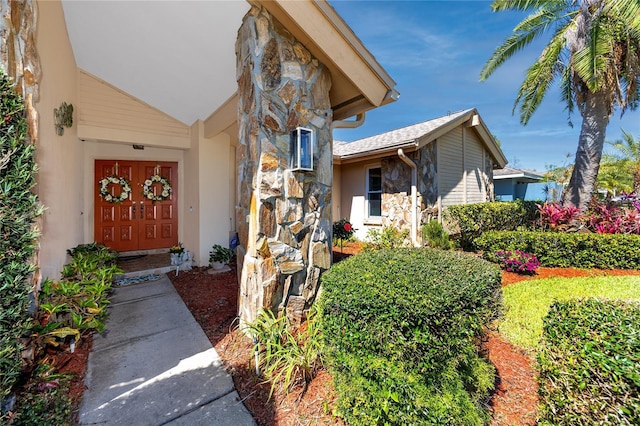 doorway to property with stone siding