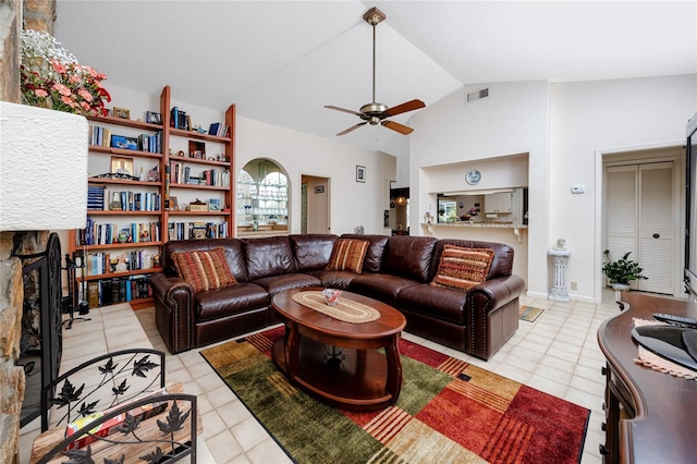 living room featuring visible vents, high vaulted ceiling, a ceiling fan, a fireplace, and light tile patterned floors