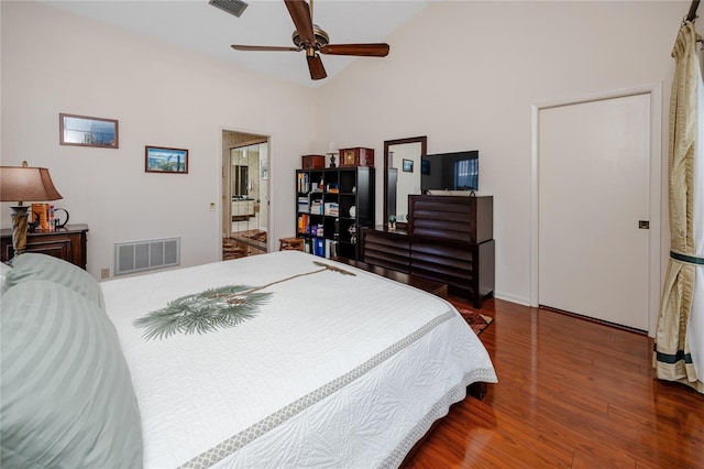 bedroom featuring ceiling fan, visible vents, lofted ceiling, and wood finished floors