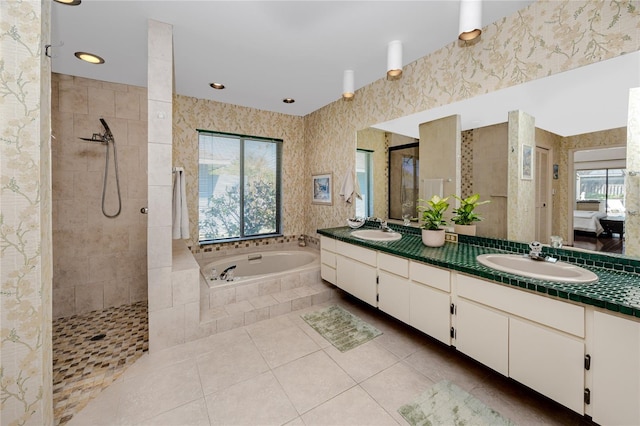 full bathroom featuring wallpapered walls, a bath, a tile shower, and a sink