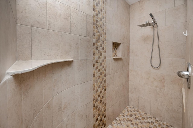 full bath featuring a tile shower