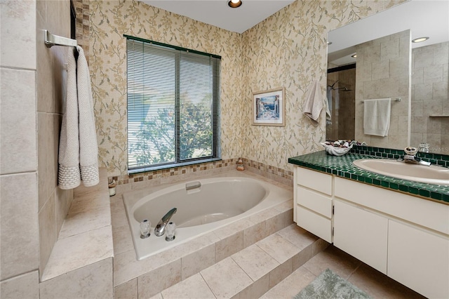 full bathroom featuring a tile shower, a bath, vanity, and wallpapered walls