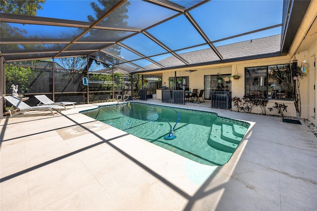 outdoor pool with a patio, a lanai, and a ceiling fan