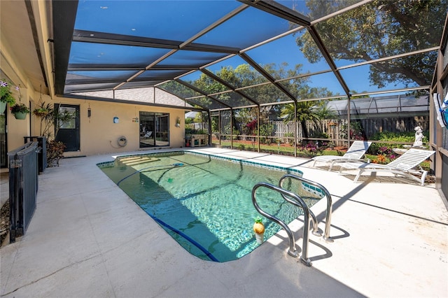 outdoor pool with fence, a lanai, and a patio area