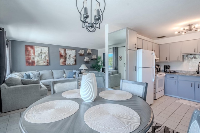 8325 112th St Unit 202, Seminole, FL 33772 - dining area with light tile patterned floors, visible vents, and a chandelier