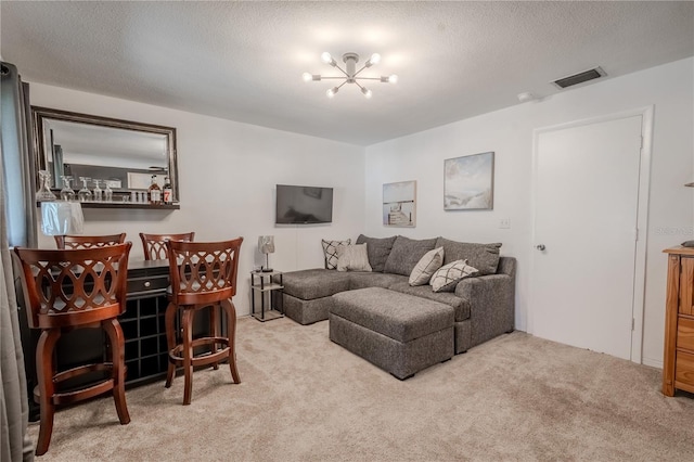 8325 112th St Unit 202, Seminole, FL 33772 - living area featuring an inviting chandelier, visible vents, carpet floors, and a textured ceiling