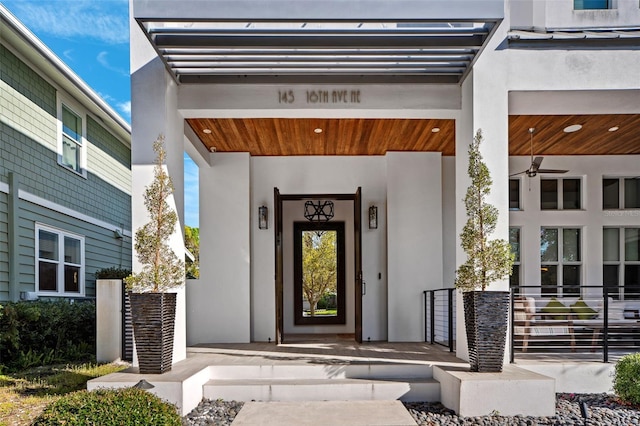 entrance to property featuring stucco siding and a porch