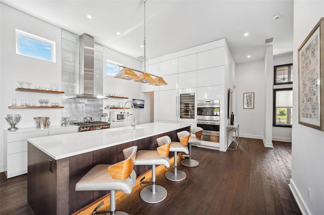 kitchen featuring white cabinets, modern cabinets, wall chimney exhaust hood, and open shelves