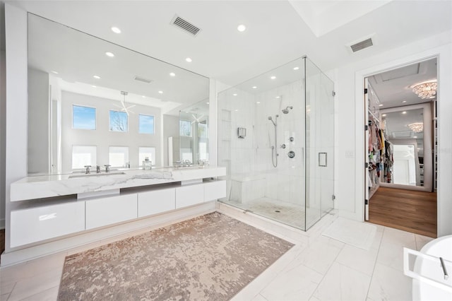 full bathroom with recessed lighting, visible vents, vanity, and a shower stall