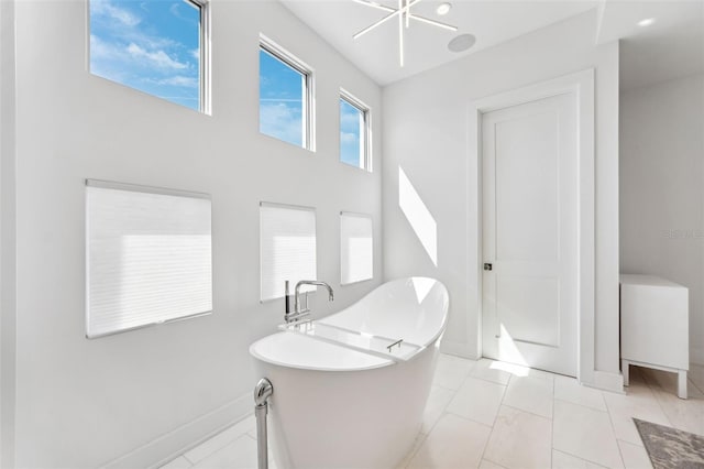 bathroom featuring baseboards and a freestanding bath