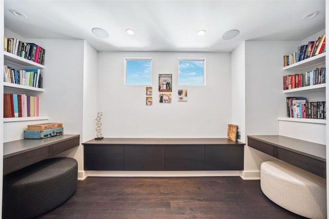 living area featuring dark wood finished floors, recessed lighting, baseboards, and built in study area