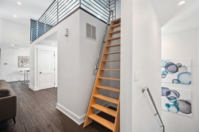 stairs featuring visible vents, recessed lighting, baseboards, and wood finished floors