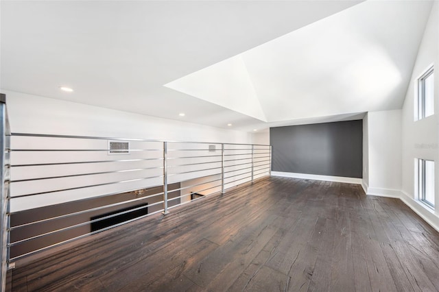 interior space with wood finished floors, visible vents, baseboards, lofted ceiling, and recessed lighting