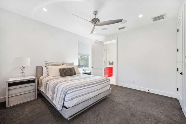 bedroom featuring baseboards, visible vents, dark colored carpet, and connected bathroom