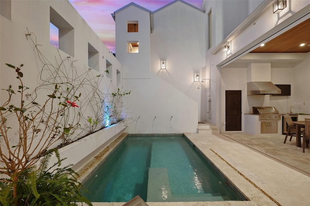 pool at dusk featuring an outdoor pool and grilling area